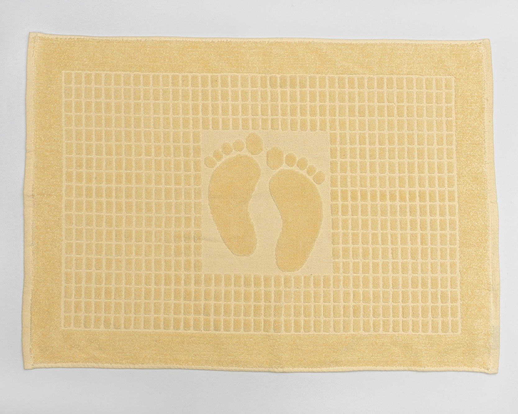 Husseinyoussef bathroom foot pedal mat in neutral color, designed for hands-free bathroom fixture operation.