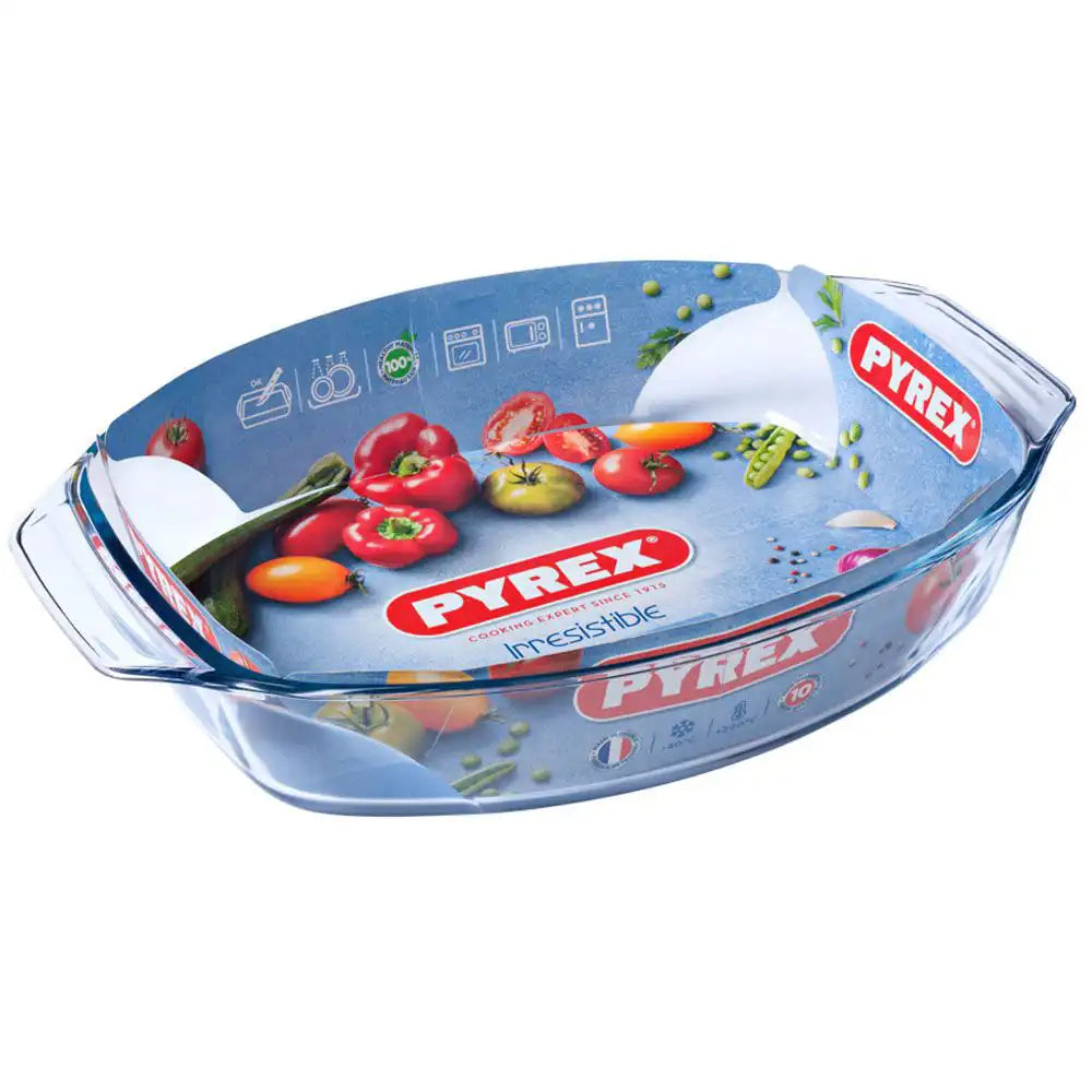 Pyrex oval baking dish with lid, white ceramic material, ideal for oven cooking and food preparation.
