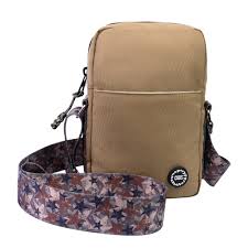 Brown cross body bag by CUBS with adjustable strap and sleek design, shown on a neutral background.
