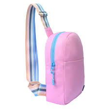 Light pink sling bag with front pocket by CUBS, featuring a sleek design and adjustable strap.