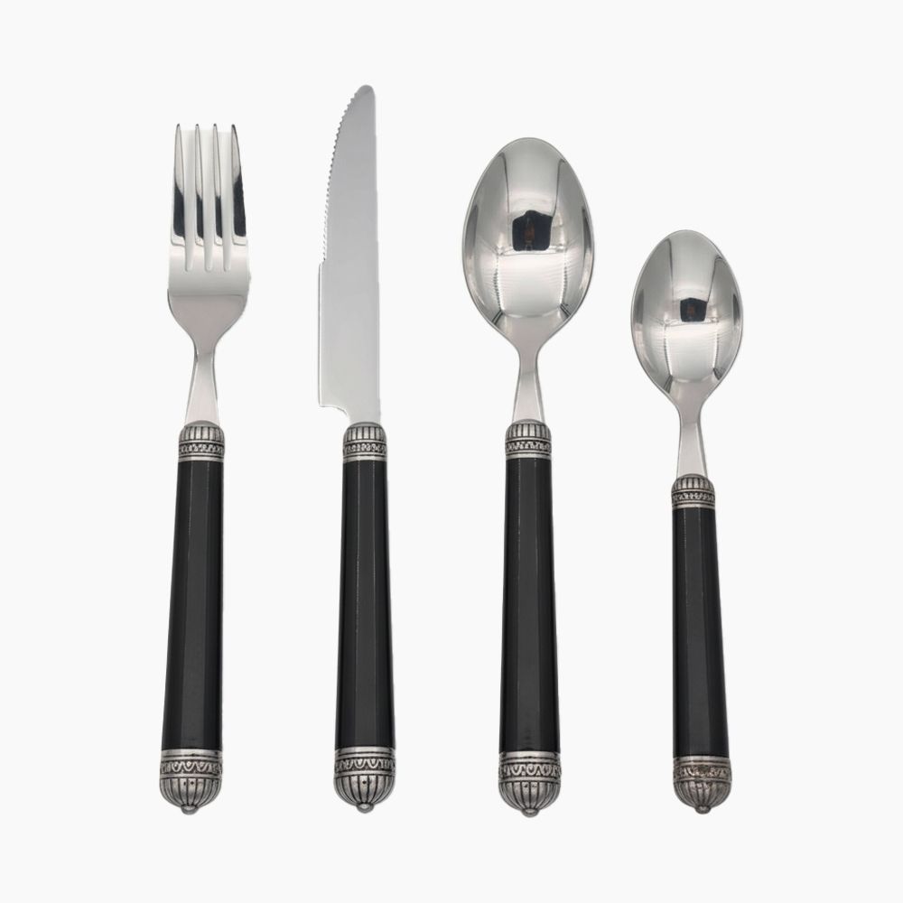 ZINNIA 24-piece cutlery set with stainless steel forks, spoons, and knives arranged on a dining table.