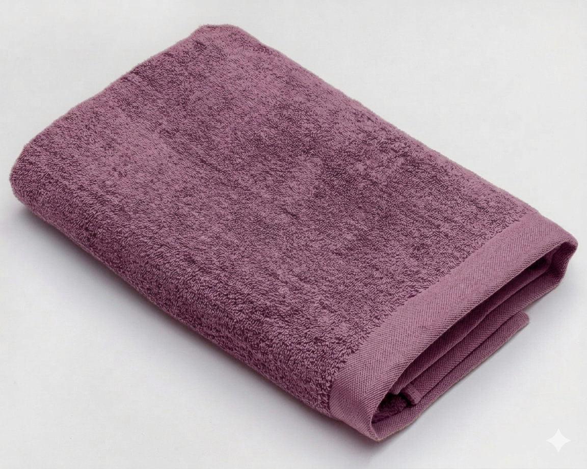 White cotton towel with wide border, measuring 50x100 cm, from MODA HOME, shown folded and draped on a neutral background.