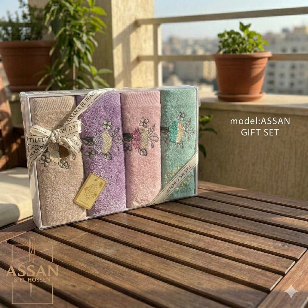 Turkish bathroom towel set with four soft, absorbent towels in neutral colors, made by Towel brand, displayed folded on a surface.