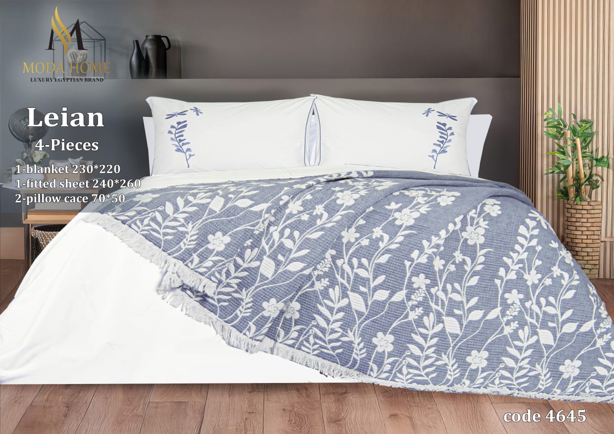 MODA HOME Layan Ghosn 4-piece coverlet set with decorative bedding in a cozy bedroom scene.