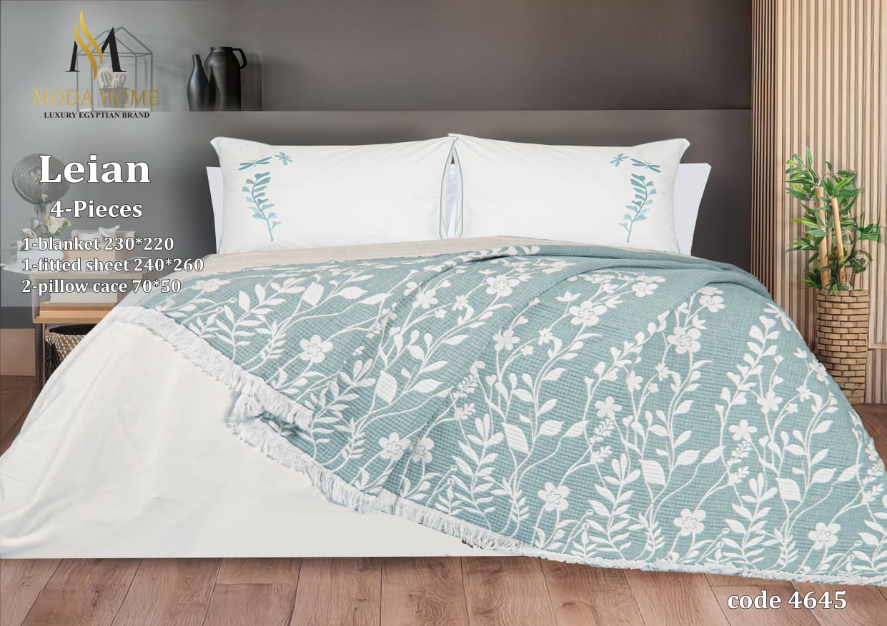 MODA HOME Layan Ghosn 4-piece coverlet set with decorative pillows in a cozy bedroom setting, featuring soft fabric and elegant design.