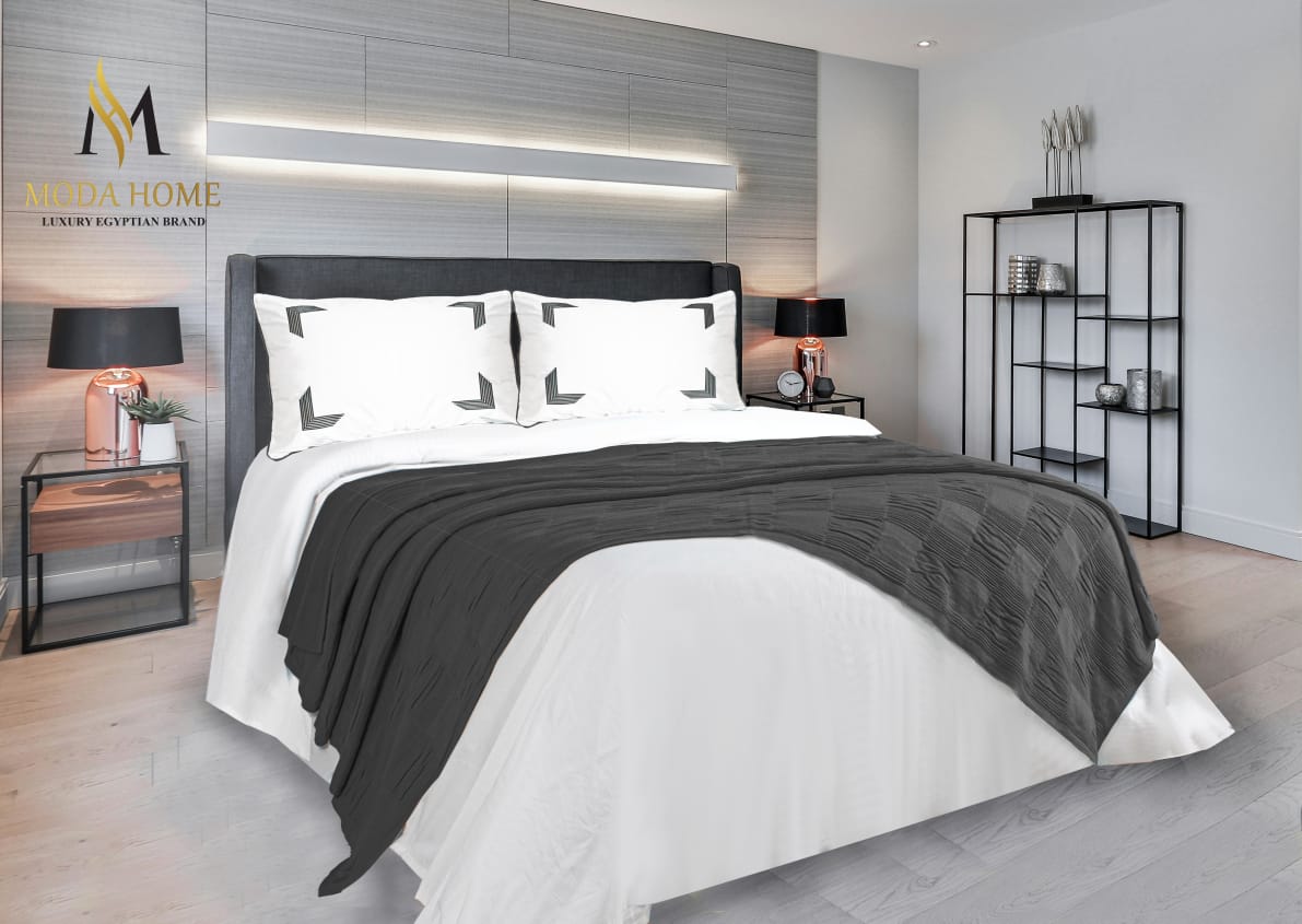 MODA HOME X-One Plain 4-piece coverlet set with matching pillowcases, featuring a smooth, solid fabric in neutral tones.